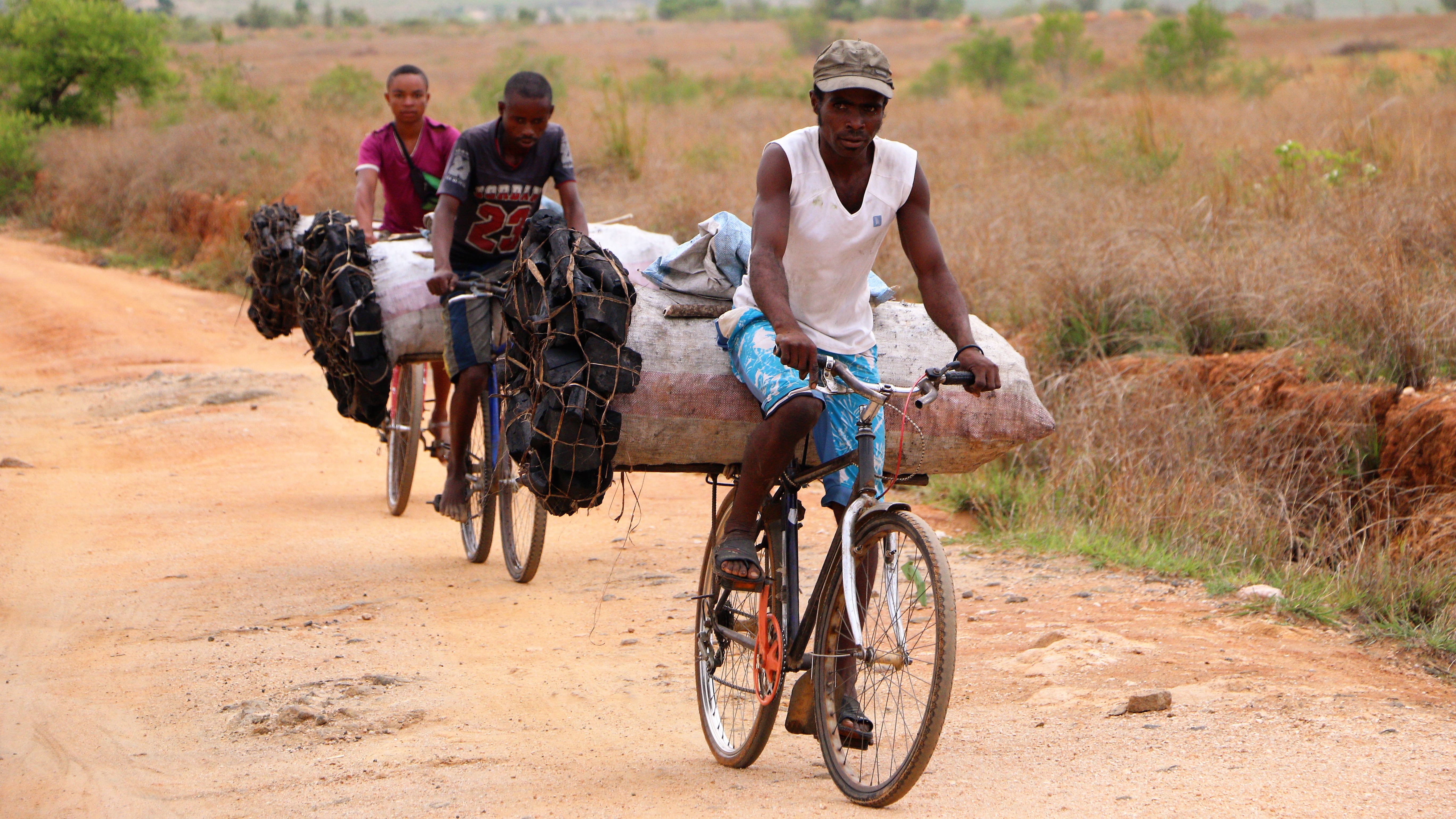 They travelled for hours, from some dozens of kilometers away from the town to get these big and heavy bags of charcoal, and will sell them in the town. Ihosy / South of Madagascar